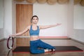 In the gym, a young woman in sportswear is engaged with a pilates ring Royalty Free Stock Photo