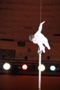 Gymnast balancing and performing number high above circus arena