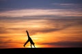 Gymnast doing cartwheel in sunset Royalty Free Stock Photo