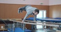 Gymnast doing planche exercise on parallel bars