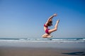 Gymnast girl doing splits grand jete in the air. Beautiful young fit gymnast woman working out, performing art Royalty Free Stock Photo