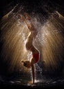 Gymnast in the spray of water Royalty Free Stock Photo