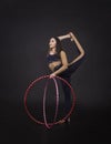 Gymnastic exercises with hula Hoop girl performs a circus artist.