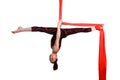 Gymnastic girl exercising on red fabric rope