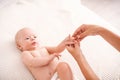 Gymnastics baby. mom doing exercises with child for its development.Hand massage