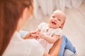 Gymnastics baby. woman doing exercises with baby for its development. massage a small newborn baby