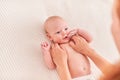 Gymnastics baby. woman doing exercises with baby for its development. massage a small newborn baby