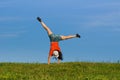Gymnastics woman doing cartwheel on nature backgrounds Royalty Free Stock Photo