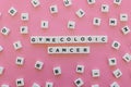 Gynecologic cancer word made of square letter word on pink background.