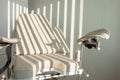 Gynecological chair. Morning light strips through the blinds. Medical office for examination of women in the hospital. Royalty Free Stock Photo