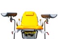 Gynecological chair yellow full-face on a white isolated background.