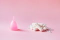 menstruation products to chose, pink silicone menstrual cup and cotton tampon for critical days, zero waste and healthy lifestyle