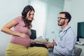 Gynecologist doctor and pregnant woman meeting at hospital Royalty Free Stock Photo