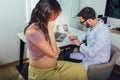 Gynecologist doctor and pregnant woman meeting at hospital Royalty Free Stock Photo