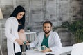 A gynecologist examines a pregnant woman. Fetal doppler heart auscultation