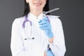 Gynecologist holding mirror instrument in his hands closeup