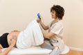 Gynecologist holding a pelvic floor muscle exercise device to prepare for the giving of birth of a woman