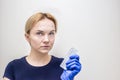 Gynecologist holds a pack of oral contraceptives in his hand