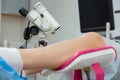 A gynecologist performs a colposcopy on a young girl in a gynecological chair in a modern medical office. Prevention and Royalty Free Stock Photo