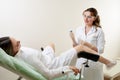 Gynaecologist examining a patient sitting on gynecological chair