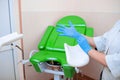 Gynecologist puts on gloves on the background of a gynecological chair. Medical examination Royalty Free Stock Photo