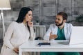 Gynecology consultation. The doctor shows the results of the ultrasound of a pregnant woman on a laptop Royalty Free Stock Photo