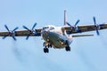 Cavok Air Antonov An-12 cargo plane at airport apron with marshaller. Air freight and shipping. Aviation and aircraft