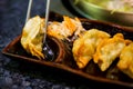 Gyoza on chopsticks. Homemade Asian Vegeterian Potstickers with soy sauce and pork.Japanese Dumplings with chopsticks. Royalty Free Stock Photo
