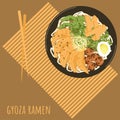 Gyoza ramen soup with chopsticks on bamboo placemat poster. Asian food with noodles, gyoza dumplings, menma, egg, pea pods, radish