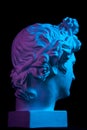 Gypsum copy of ancient statue Apollo head isolated on black background. Plaster sculpture man face. Royalty Free Stock Photo