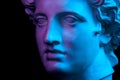 Gypsum copy of ancient statue Apollo head isolated on black background. Plaster sculpture man face. Royalty Free Stock Photo