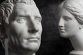 Gypsum copy of ancient statue Augustus and Venus head on dark textured background. Plaster sculpture mans face. Royalty Free Stock Photo