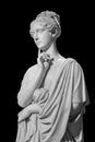 Gypsum copy of ancient statue of thinking young lady isolated on black background. Side view of plaster sculpture woman Royalty Free Stock Photo