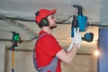 Gypsum plasterboard work. Drywall construction at home. Contractor worker installing metal frame on ceiling Royalty Free Stock Photo