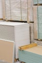 Gypsum plasterboard in the pack. The stack of gypsum board preparing for construction. Pallet with plasterboard in the building Royalty Free Stock Photo