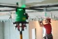 Gypsum plasterboard work. Drywall construction at home. Contractor worker installing metal frame on ceiling Royalty Free Stock Photo