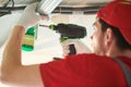 Gypsum plasterboard work. Drywall construction at home. Contractor worker installing metal frame on ceiling Royalty Free Stock Photo