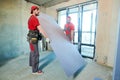 Gypsum plasterboard work. Drywall construction at home. Contractor worker installing wall Royalty Free Stock Photo