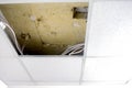 Gypsum squares of a false ceiling. Broken suspended ceiling plate