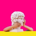 Gypsum statue of Antinous head. Creative. Plaster statue of Aphrodite`s head in women hends  . Royalty Free Stock Photo