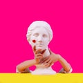 Gypsum statue of Aphrodite head. Creative. Plaster statue of Aphrodite`s head in women hends on a pink background Royalty Free Stock Photo