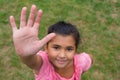 Gypsy child offering hand for high five against racism, shot fro