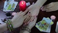 A Gypsy fortune teller reads her hand by candlelight and Tarot cards. The palmist tells fortunes by the lines of the hand