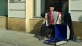 OLOMOUC, CZECH REPUBLIC, FEBRUARY 29, 2019: Gypsy man in city begging money into a cup, authentic plays music the