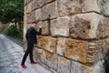 Gypsy man dancing flamenco, young and handsome, dressed in black, leaning angrily on a wall with his fist. Flamenco cultural Royalty Free Stock Photo