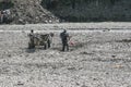 Gypsy men charging a cart