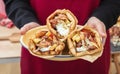 Gyro pita Shawarma, sliced meat tzatziki and vegetable wrap in male hand, close up view Royalty Free Stock Photo