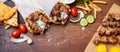 Gyro pita, shawarma, souvlaki. Two pita bread wraps and meat skewers on wooden table Royalty Free Stock Photo