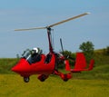 Gyroplane landing over green field