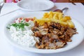 Gyros with Fries and Salad. Traditional turkish and greek meat food. Royalty Free Stock Photo